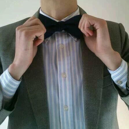 picture of me, wearing a suit and adjusting my bowtie